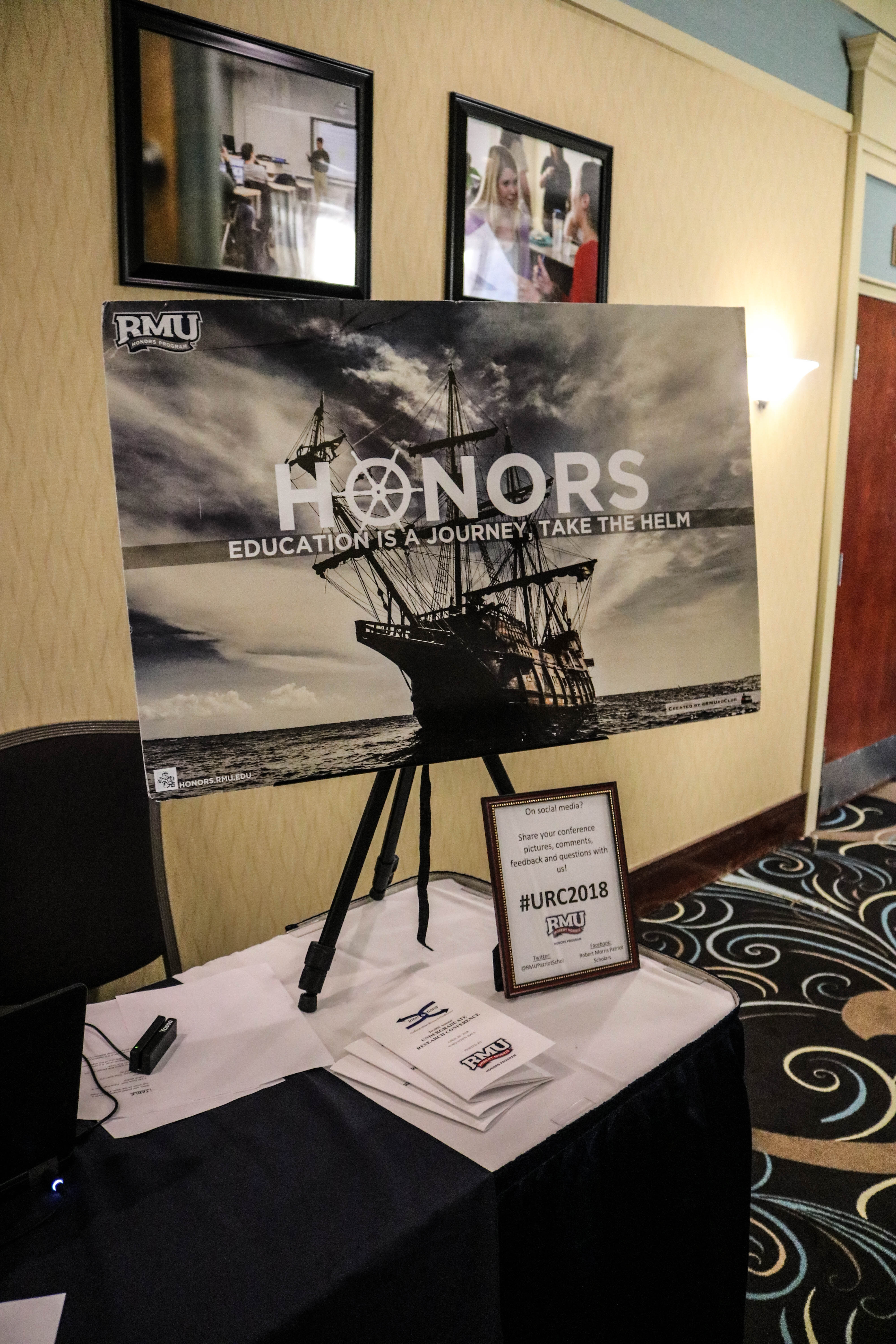 Honors "education is a journey: take the helm" poster with image of a ship.